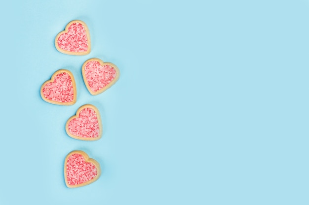 Heart shape cookies on a light blue background in a top view