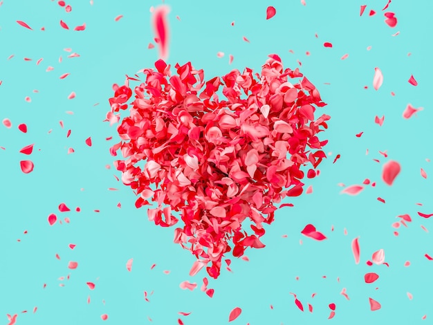 Heart shape formed by red petals on turquoise background