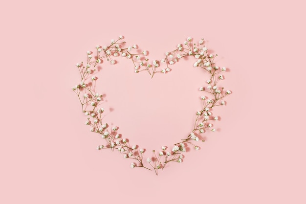 Heart shape from gypsophila flowers in pink table