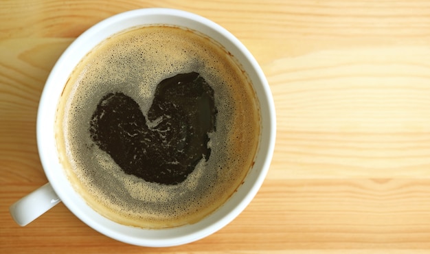 Heart shape hot black coffee foam