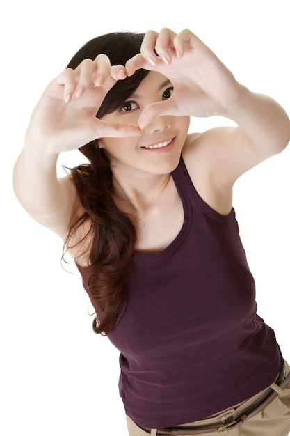 Heart shape made by young woman of Asian, closeup portrait.