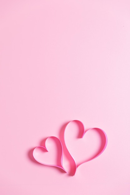 Heart shape made from ribbon on Pink