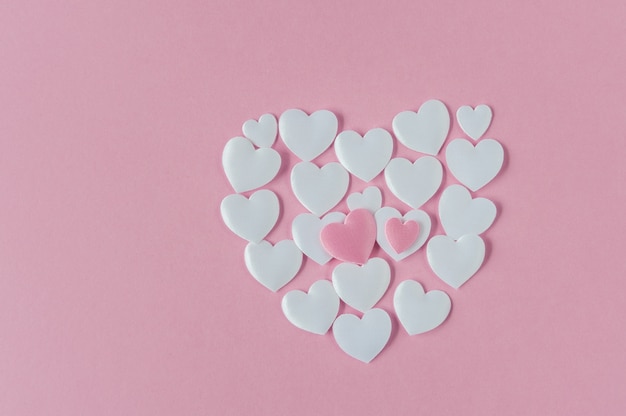 Photo heart shape made of white satin hearts on pink