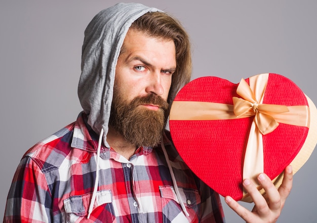 Heart shape. Man with valentines gift. Present with love. Presents and gifts.