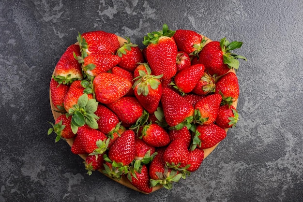 Heart shape strawberries on dark marble love for fresh fruits