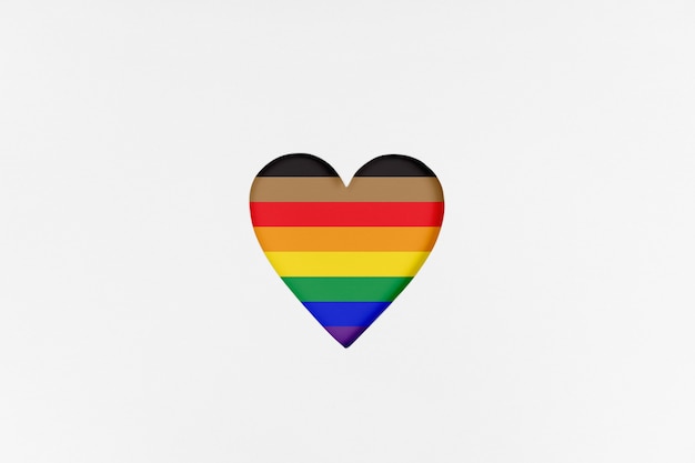 Photo heart shape with new redesigned lgbtq pride flag on white cardboard