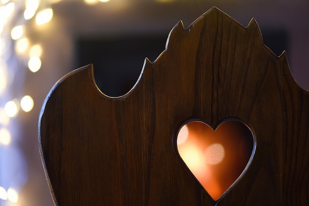 Heart shape in wood with the fire in the background