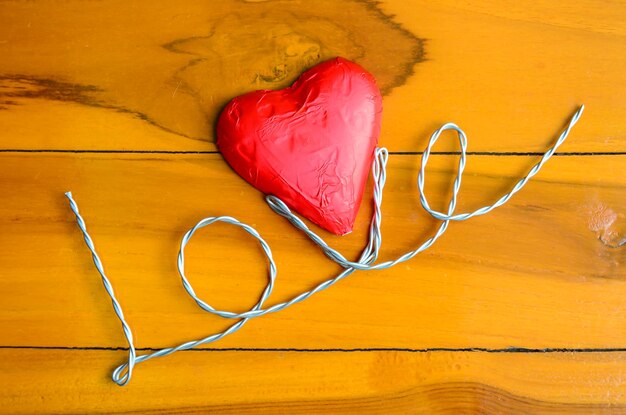 Photo heart shape wrapped chocolate on table