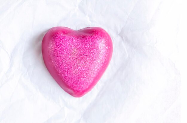 Heart shaped bar of soap on a light soft background Top view