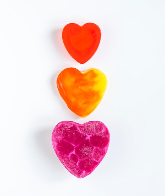 Photo heart shaped bars of soap on a light soft background top view