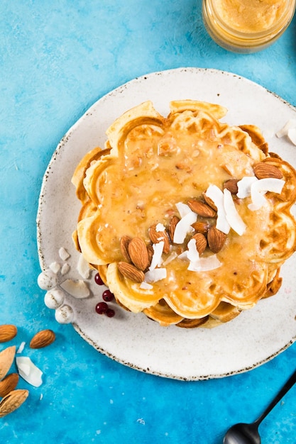 Photo heart shaped belgium waffles on blue background european pastry sweets st valentines day