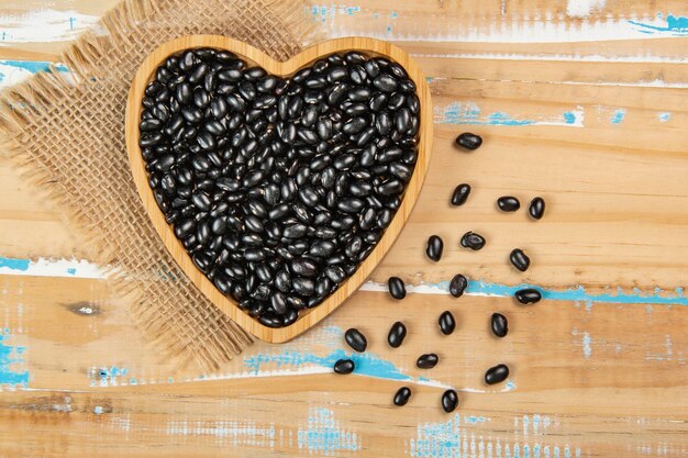 Heart shaped black bean bowl on wooden table