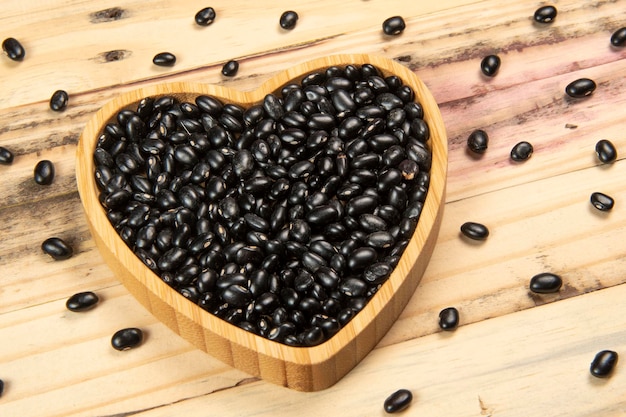 Heart shaped black bean bowl on wooden table