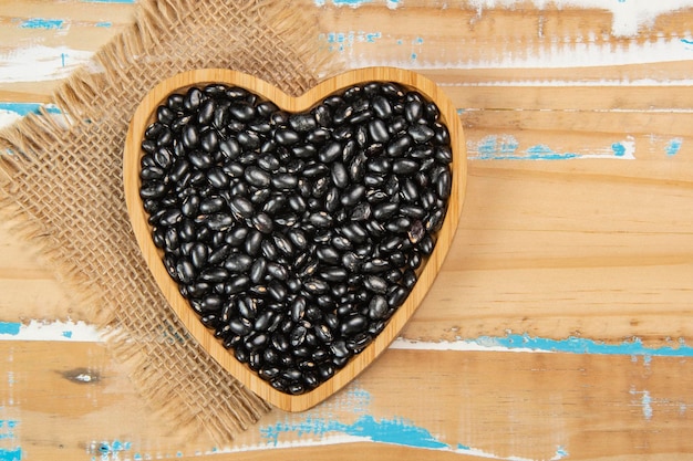 Heart shaped black bean bowl on wooden table