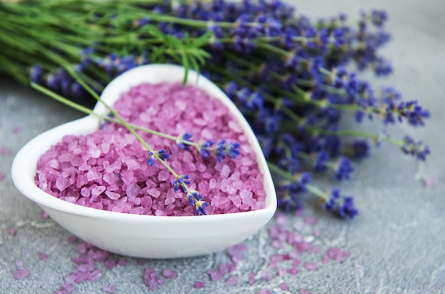 Heart-shaped bowl with sea salt and fresh lavender flowers