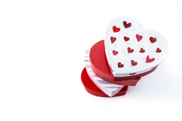 Heart shaped boxes decorated with pink and red hearts isolated on white background