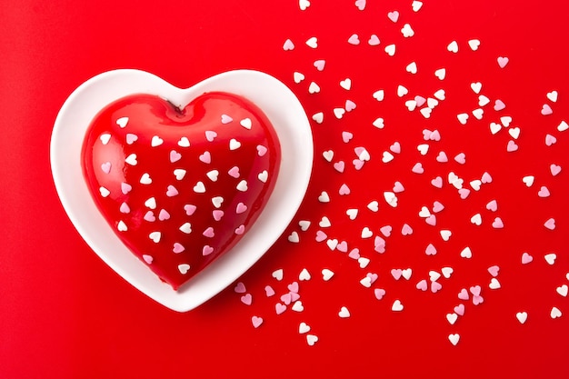 Heart shaped cake for Valentine's Day or mother's day on red background.