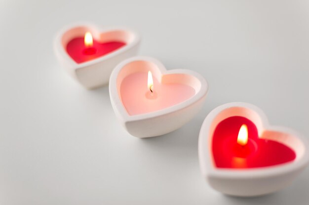 heart shaped candles burning on valentines day