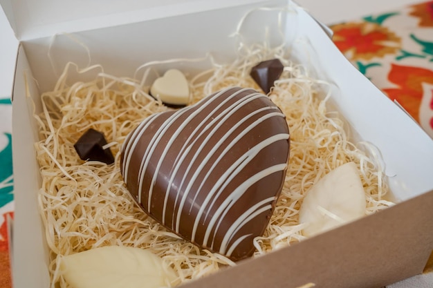 Heart shaped chocolate candy in a gift box. Romantic gift