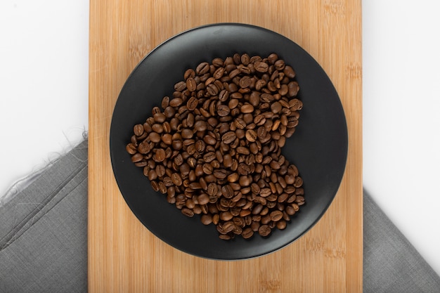 Heart shaped coffee beans on saucer