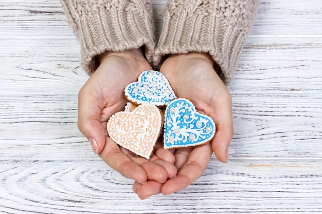 Heart shaped cookie in woman's hands holiday cookies