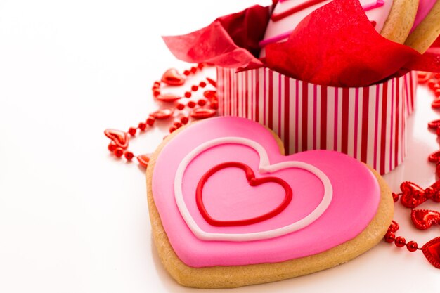 Heart shaped cookies decorated fancy icing patterns.