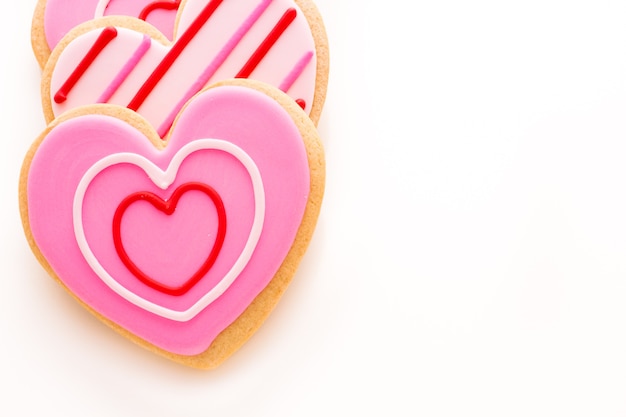 Heart shaped cookies decorated fancy icing patterns.