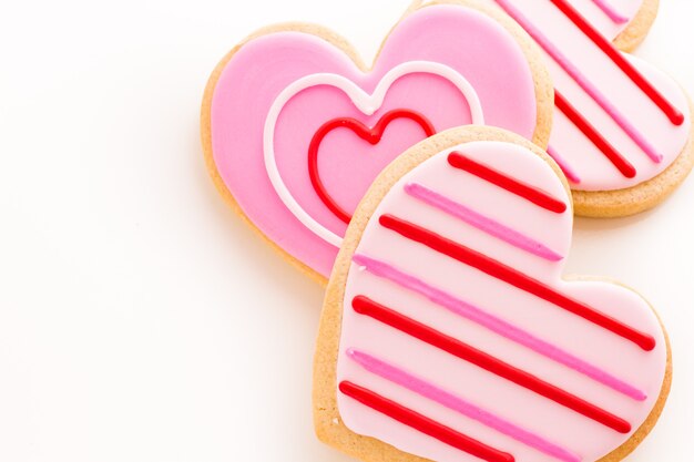 Heart shaped cookies decorated fancy icing patterns.