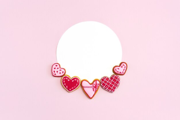 Heart shaped cookies flat lay on pink with round mockup for Valentine's day.