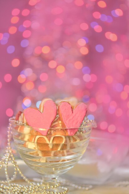 Heart shaped cookies with pink frosting on abstract blurry bokeh background Valentine heart cookies Valentines day decoration