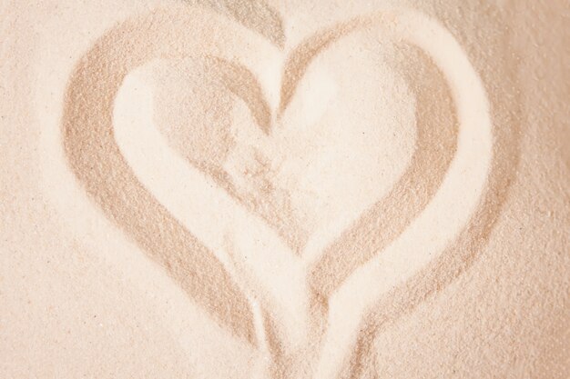 Heart-shaped draw on the beach sand