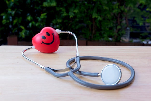 Heart shaped and equipped with a stethoscope attached to the ear 