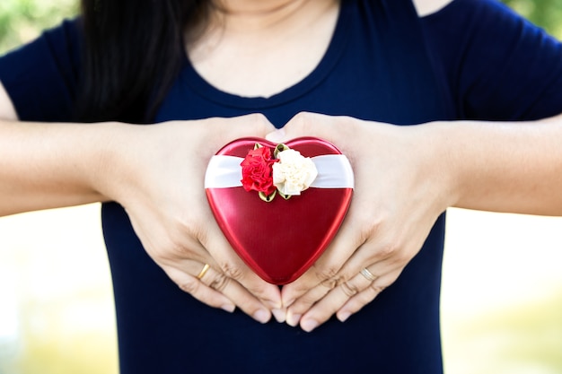 heart shaped gift box in hands