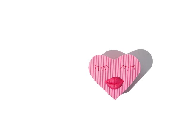 Heart shaped gift box with lips and eyelashes isolated on white