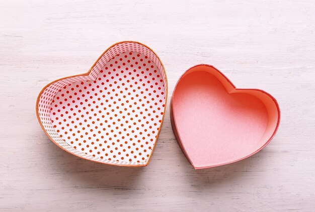 heart shaped gift boxes on a light wooden table