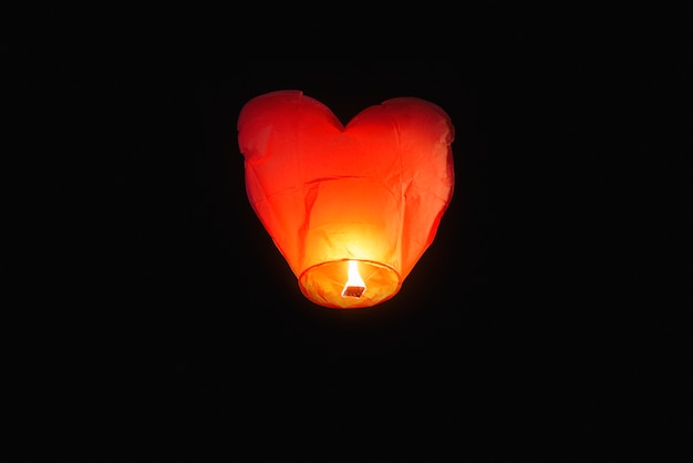 Heart shaped lamp flying with candlelight