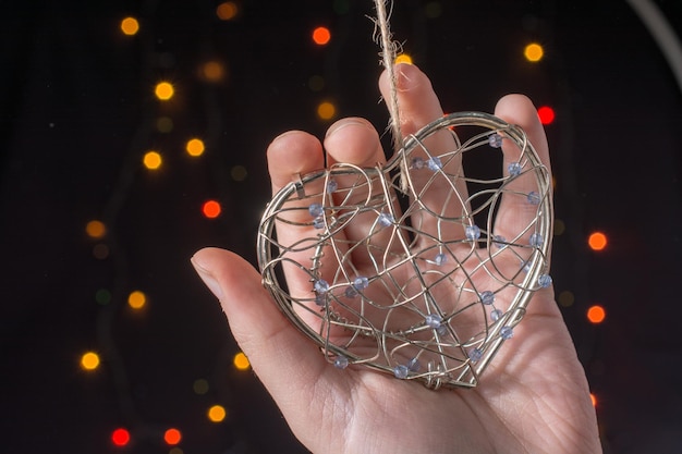 Photo heart shaped metal cage on bokeh light background