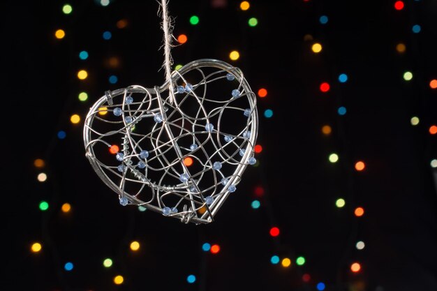 Heart shaped metal cage on a bokeh light background