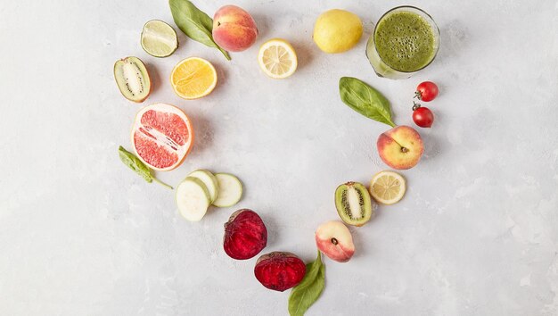 Heart shaped organic vegan vegetables and fruits with copy space in the center Keto FODMAP Paleo