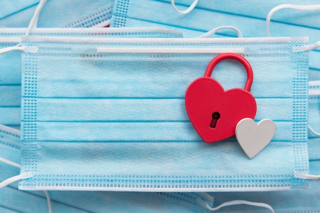 Heart shaped padlock on a protective face mask covid valentines\
day concept