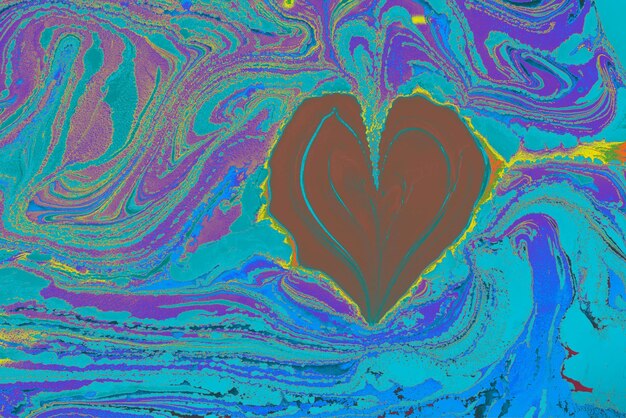 A heart shaped painting on a blue and purple background Stock Photo