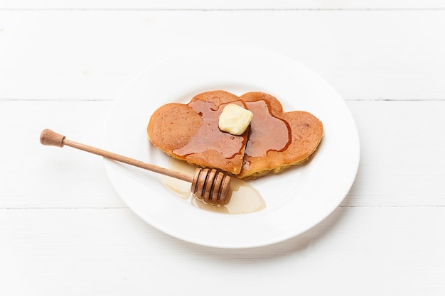 heart shaped pancakes on a light background the concept of a festive breakfast for Valentine's Day or a pleasant surprise for a loved one