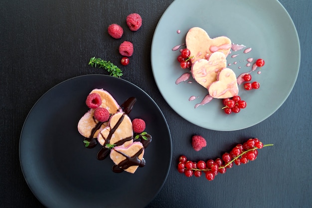 Heart shaped pancakes with currant for Valentine's day