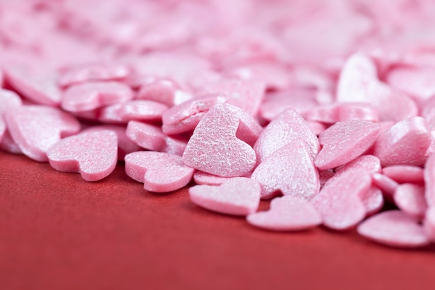 Heart-shaped pink sweet candy dessert decorations, close up