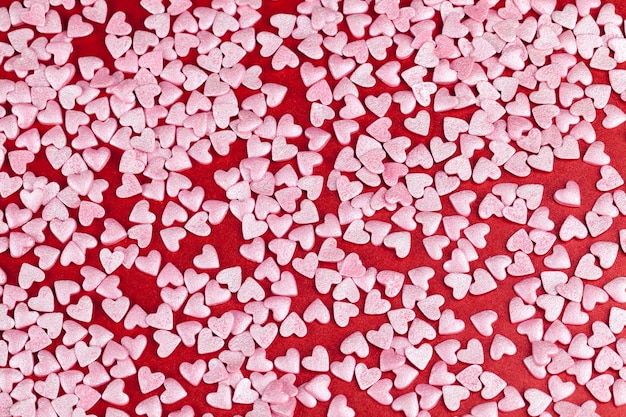 Heart-shaped pink sweet candy dessert decorations, close up