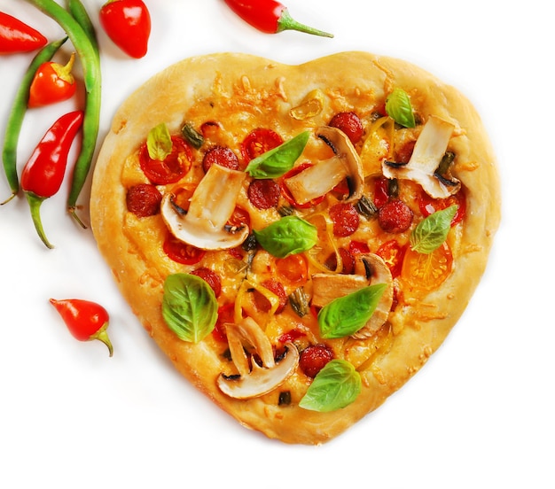 Heart shaped pizza and fresh vegetables isolated on white