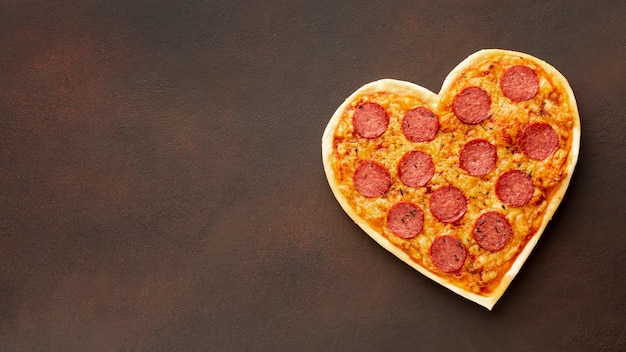 Photo heart shaped pizza with copy space