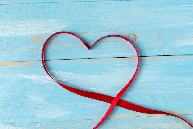 Heart shaped ribbon on a blue wooden table. Valentine's Day Gift