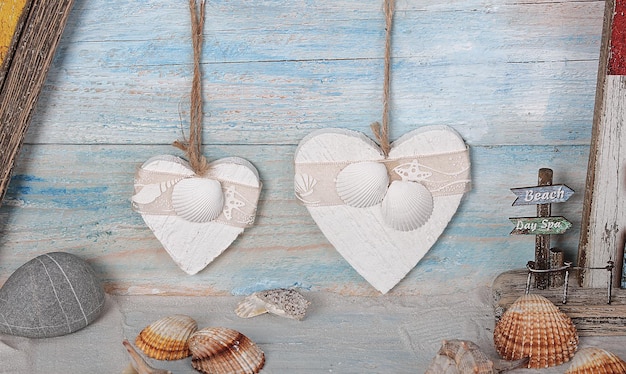 A heart shaped string with a seashell on it