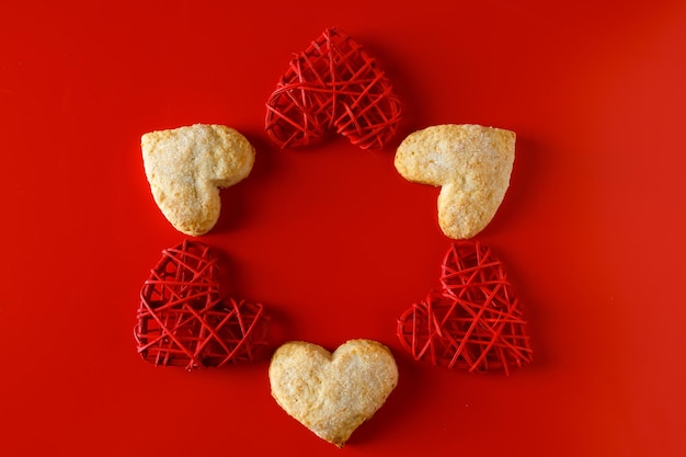 Heart shaped sugar cookies on red background